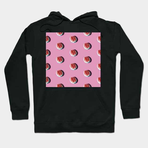 Halloween brain candy arranged in a pattern on a pink background. Hoodie by karinelizabeth